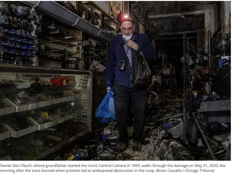 Don Flesch Walks through his shop after it was looted and burned